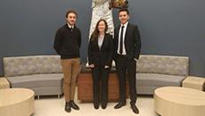 ilikenChe-Hsien Lin, Jeremiah Polander, Jessica Smith posed together in front of a statue 